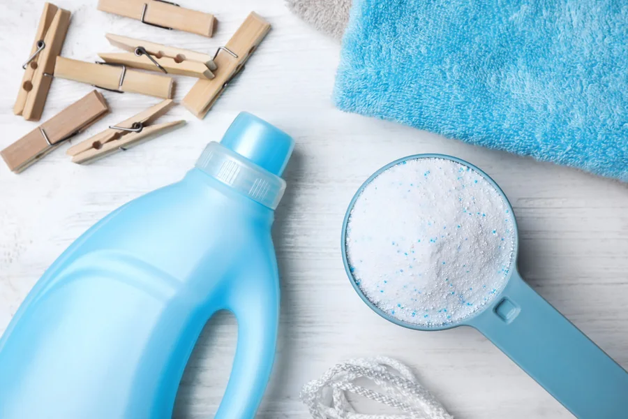 A detergent bottle, washing powder and a towel